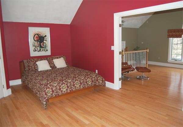 24 Carriage Drive Lexington, MA 02420 - Photo 18 of 30 a bedroom with a bed and wooden floor