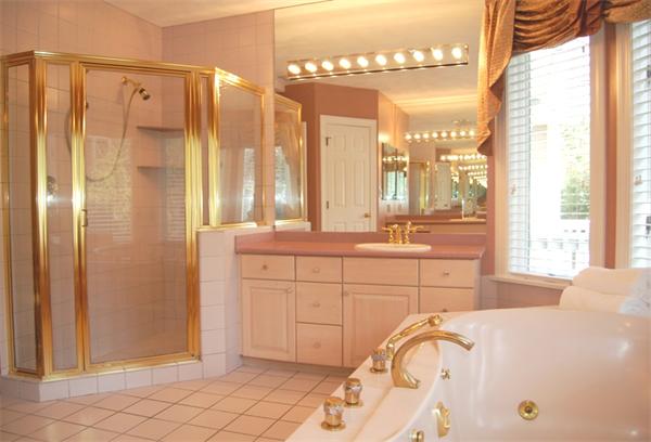 24 Carriage Drive Lexington, MA 02420 - Photo 23 of 30 a spacious bathroom with a double vanity sink a mirror a bathtub and next to a window
