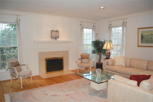 24 Carriage Drive Lexington, MA 02420 - Photo 3 of 30 a living room with furniture and a fireplace