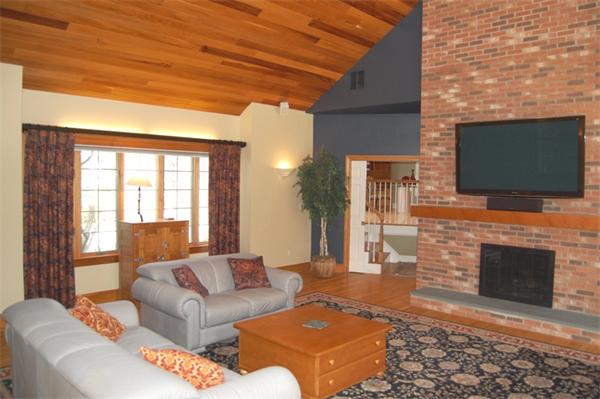 24 Carriage Drive Lexington, MA 02420 - Photo 8 of 30 a living room with furniture a flat screen tv and a fireplace