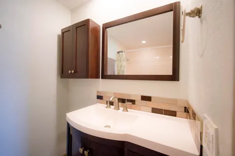a bathroom with a sink and a mirror