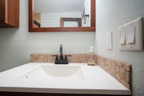 a kitchen with a sink and cabinets