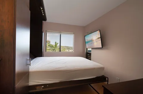 a bedroom with a bed and two lamps