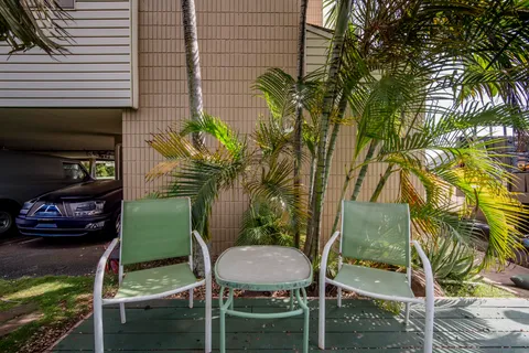 a backyard of a house with table and chairs