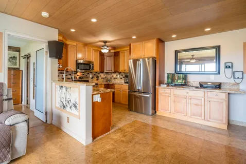 a kitchen with stainless steel appliances a refrigerator and a stove top oven