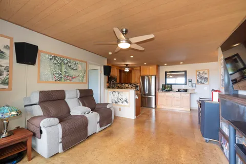 a living room with furniture and kitchen view