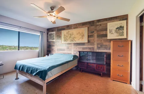 a bedroom with a bed and a dresser