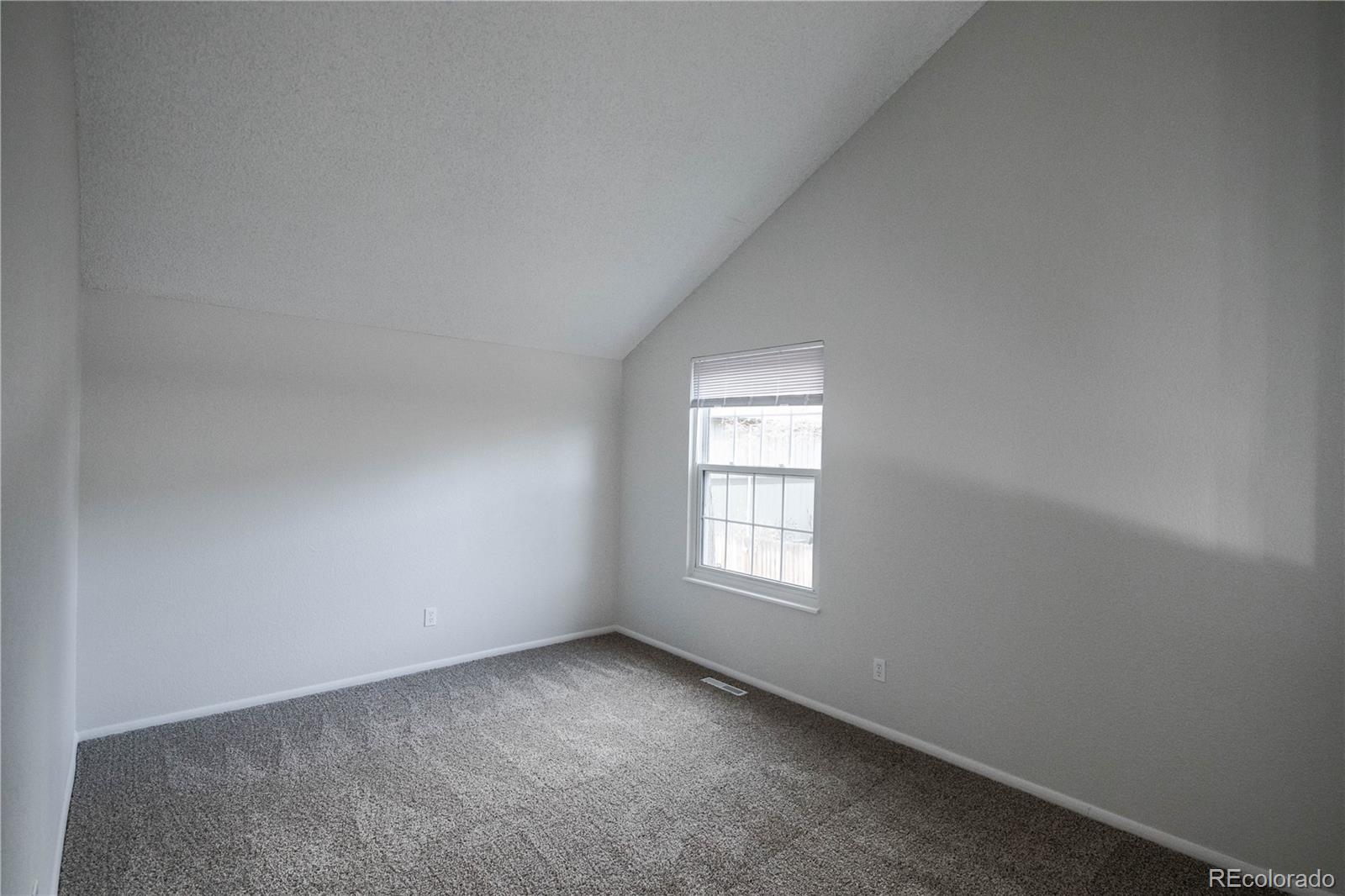 2920 South Racine Street Aurora, CO 80014 - Photo 12 of 36 an empty room with windows