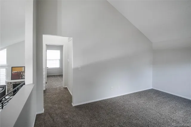 a view of a hallway with a livingroom and a bathroom sink