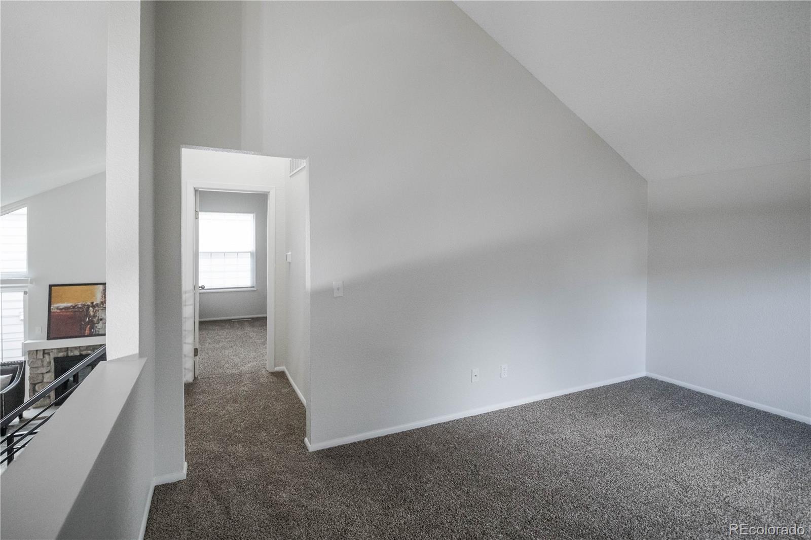 2920 South Racine Street Aurora, CO 80014 - Photo 13 of 36 a view of a hallway with a livingroom and a bathroom sink