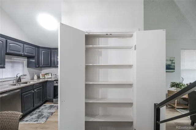 a kitchen with a sink a stove and cabinets
