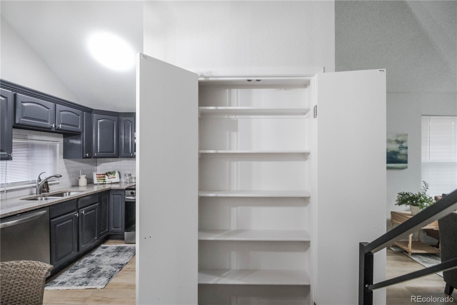 2920 South Racine Street Aurora, CO 80014 - Photo 18 of 36 a kitchen with a sink a stove and cabinets