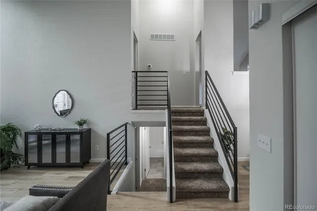 a view of entryway and hall with wooden floor