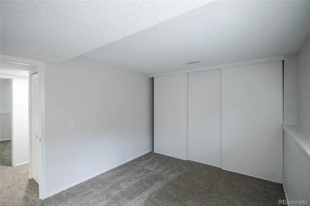 a view of an empty room and closet area