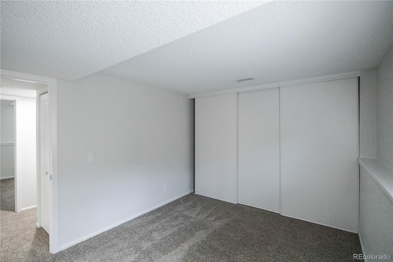 2920 South Racine Street Aurora, CO 80014 - Photo 25 of 36 a view of an empty room and closet area