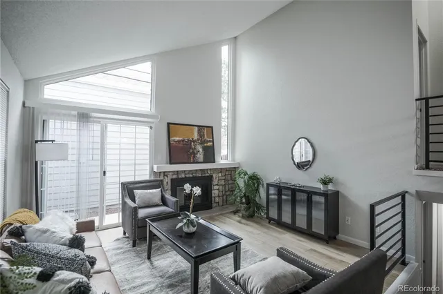 a living room with furniture a window and a flat screen tv