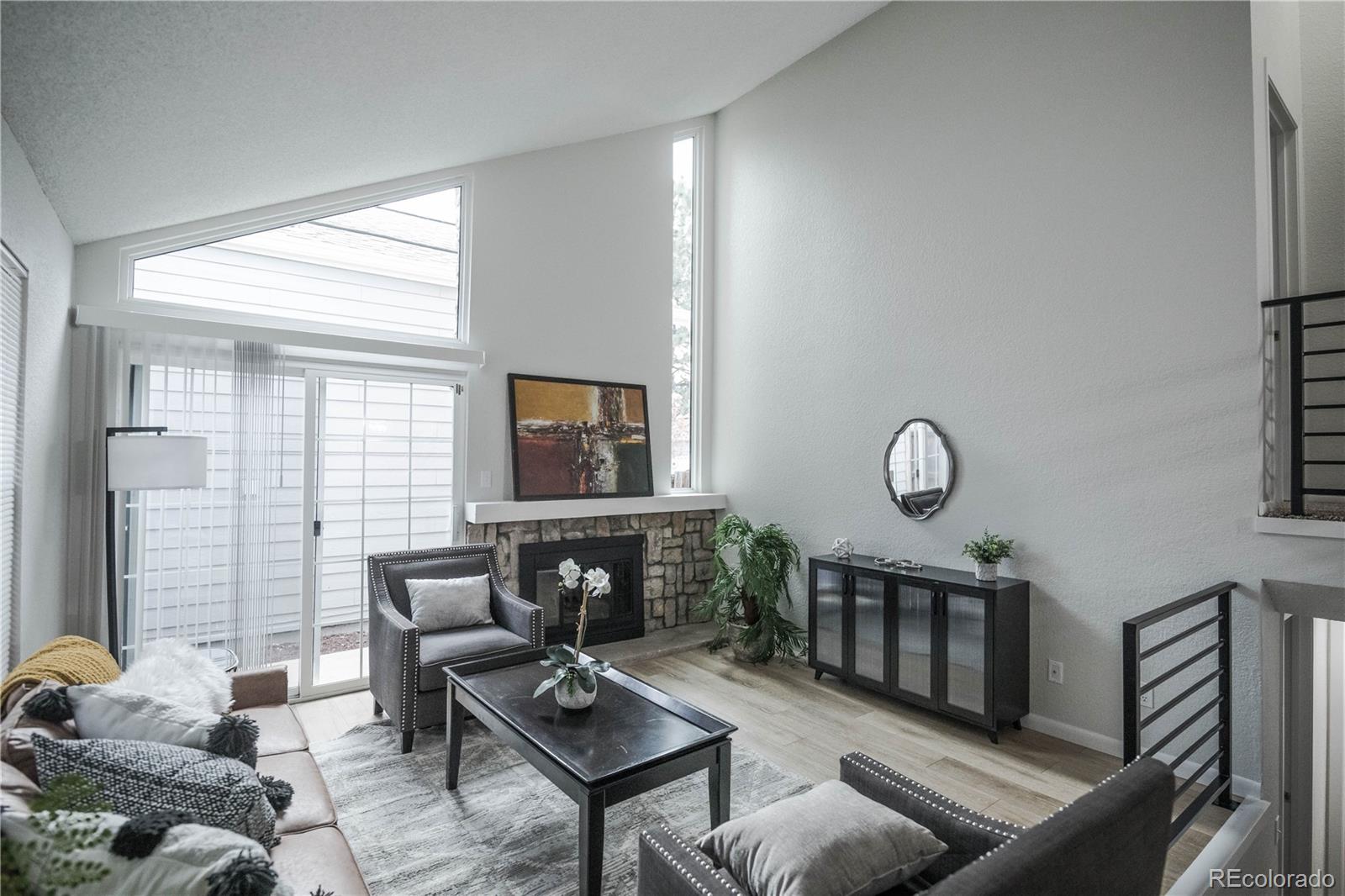 2920 South Racine Street Aurora, CO 80014 - Photo 4 of 36 a living room with furniture a window and a flat screen tv