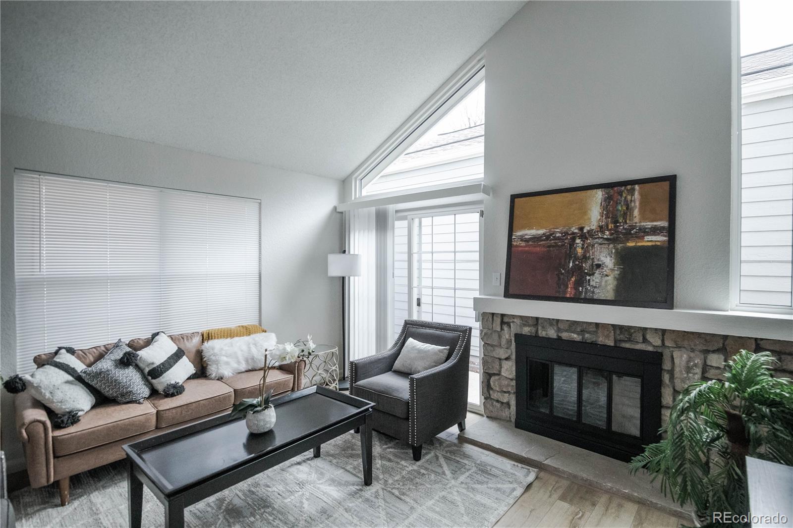 2920 South Racine Street Aurora, CO 80014 - Photo 5 of 36 a living room with furniture and a fireplace