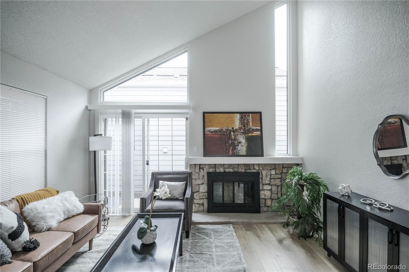 2920 South Racine Street Aurora, CO 80014 - Photo 6 of 36 a living room with furniture and a fireplace
