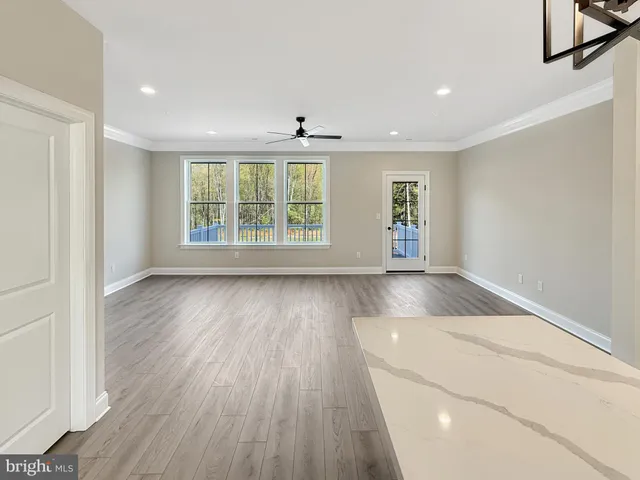 an entryway with wooden floor and windows