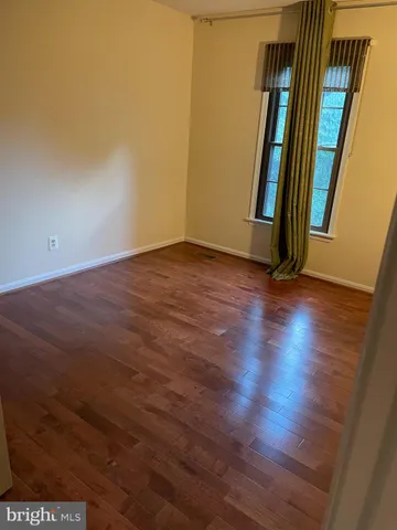 an empty room with wooden floor