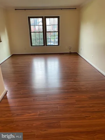 a view of lot of room with window and wooden floor