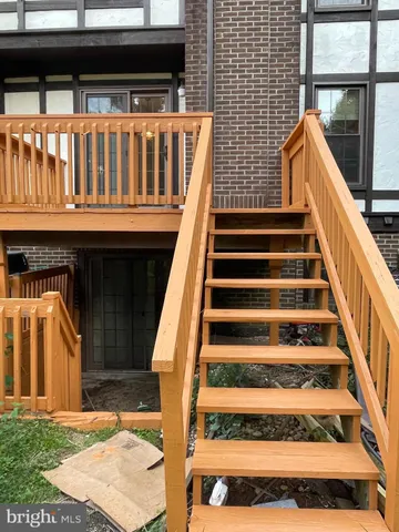 a view of entryway with wooden floor and a front door