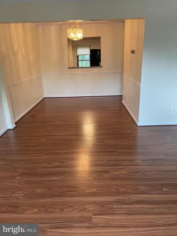 a view of a room with wooden floor and cabinet