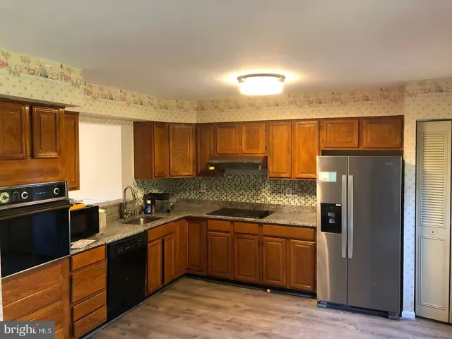 a kitchen with a sink stove and refrigerator