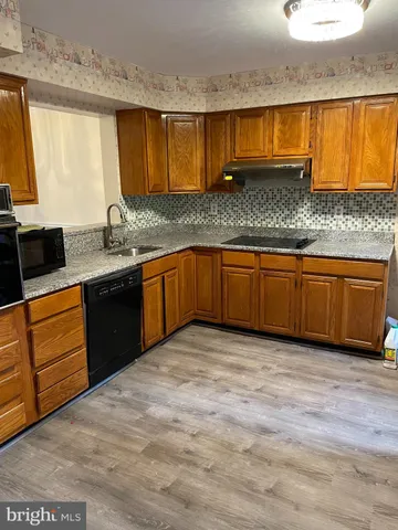 a kitchen with stainless steel appliances granite countertop a sink stove and cabinets