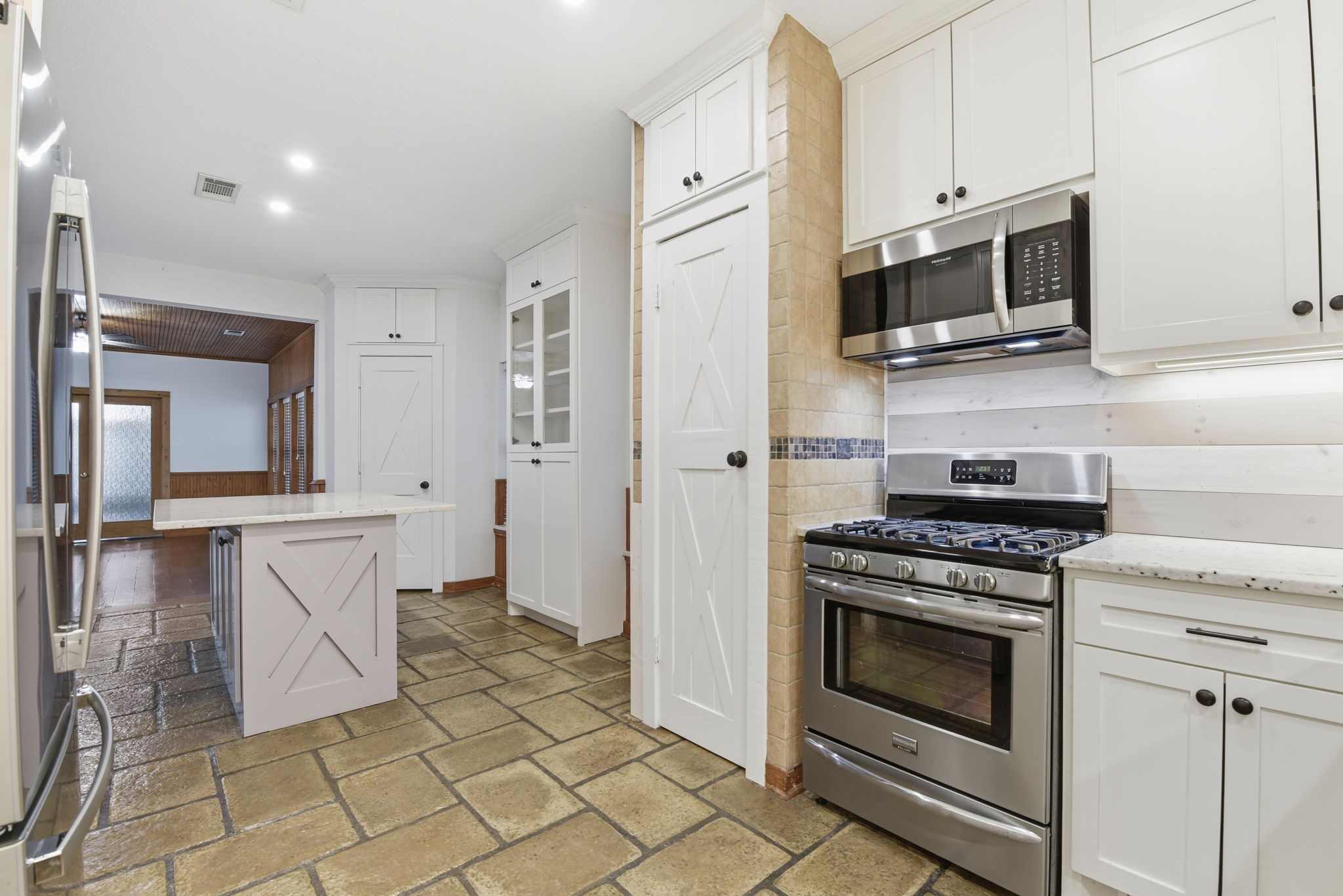 21531 Tophill Drive Spring, TX 77388 - Photo 12 of 49 a kitchen with stainless steel appliances a stove a microwave and cabinets