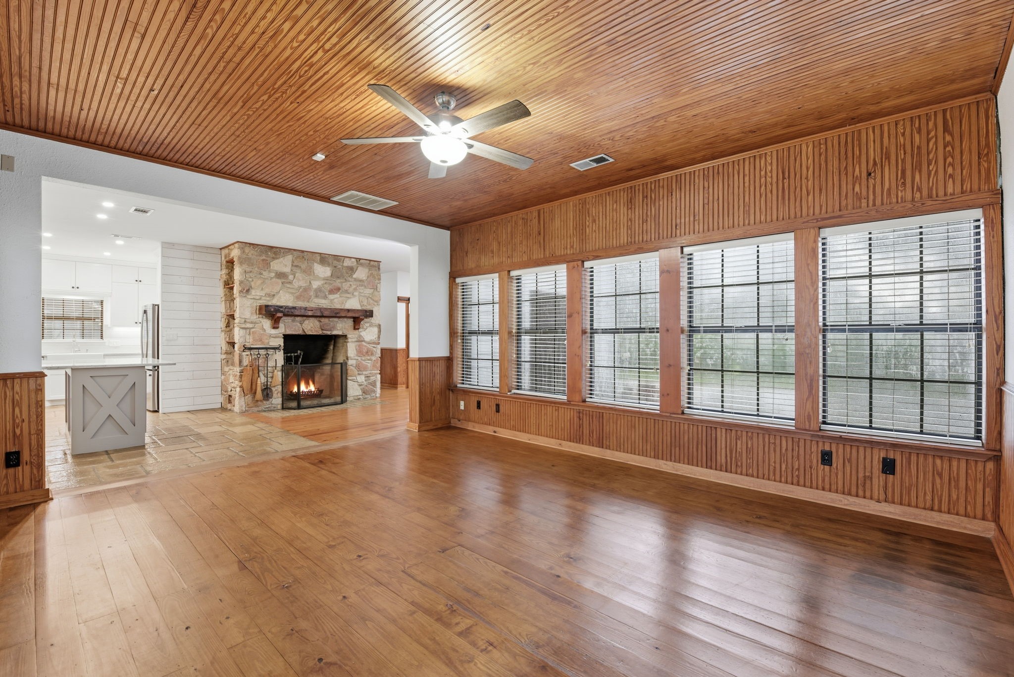 21531 Tophill Drive Spring, TX 77388 - Photo 14 of 49 an empty room with wooden floor fireplace and windows