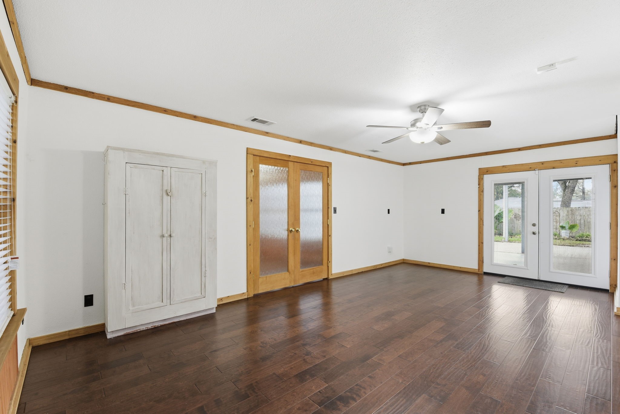 21531 Tophill Drive Spring, TX 77388 - Photo 19 of 49 a view of an empty room with a window and wooden floor
