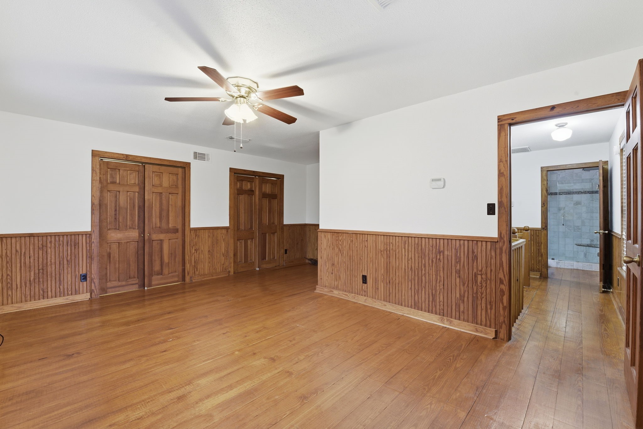 21531 Tophill Drive Spring, TX 77388 - Photo 26 of 49 a view of an empty room with wooden floor and a ceiling fan