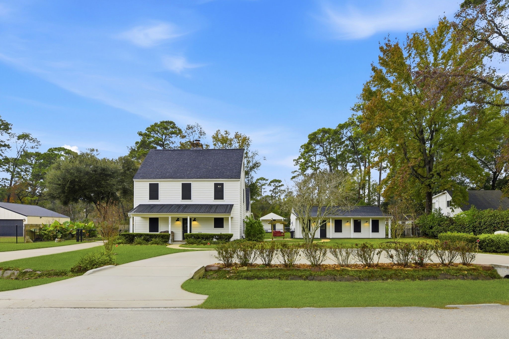 21531 Tophill Drive Spring, TX 77388 - Photo 3 of 49 a front view of a house with a yard and potted plants
