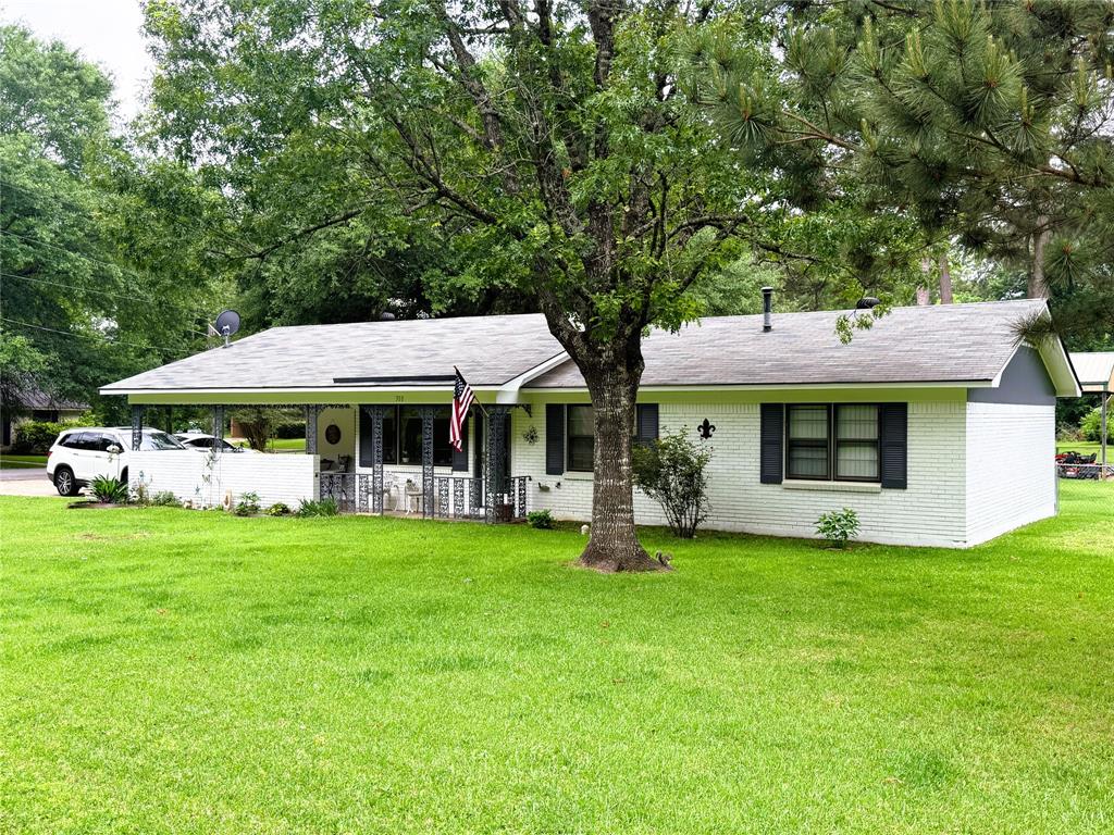a view of a house with a yard and sitting area