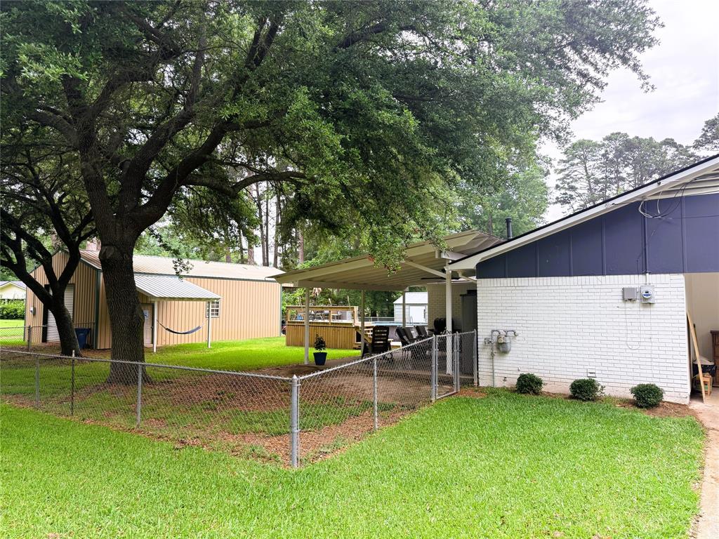 310 Murray Lane Haughton, LA 71037 - Photo 13 of 17 a view of a backyard with table and chairs and a large tree
