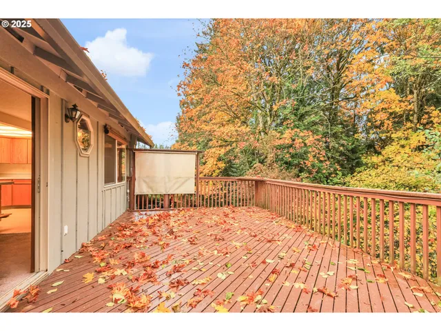 a view of balcony with wooden floor and fence