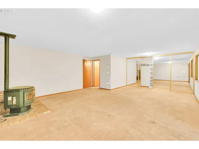 a view of an empty room with a fireplace