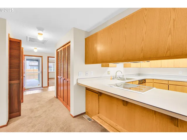 a view of a kitchen with a sink and cabinets