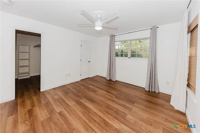 a spacious bedroom with a large bed and a window