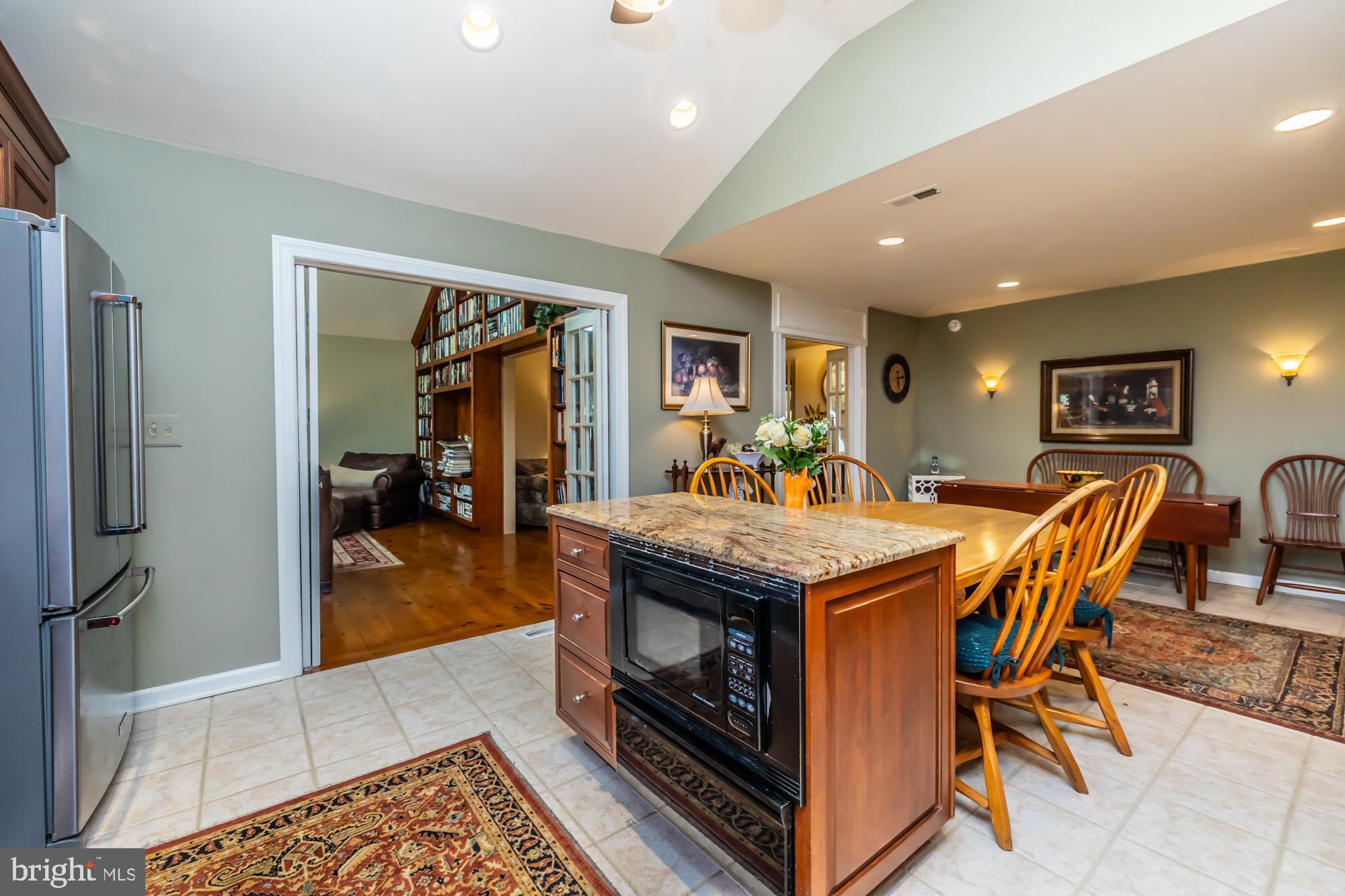 414 Manor Drive Kennett Square, PA 19348 - Photo 19 of 35 a dining hall with a dining table and chairs with wooden floor