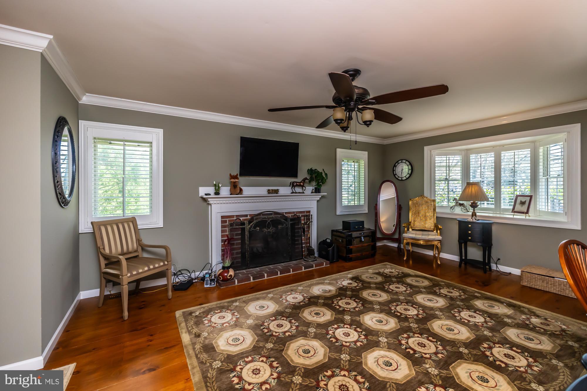 414 Manor Drive Kennett Square, PA 19348 - Photo 22 of 35 a living room with furniture a fireplace and a flat screen tv