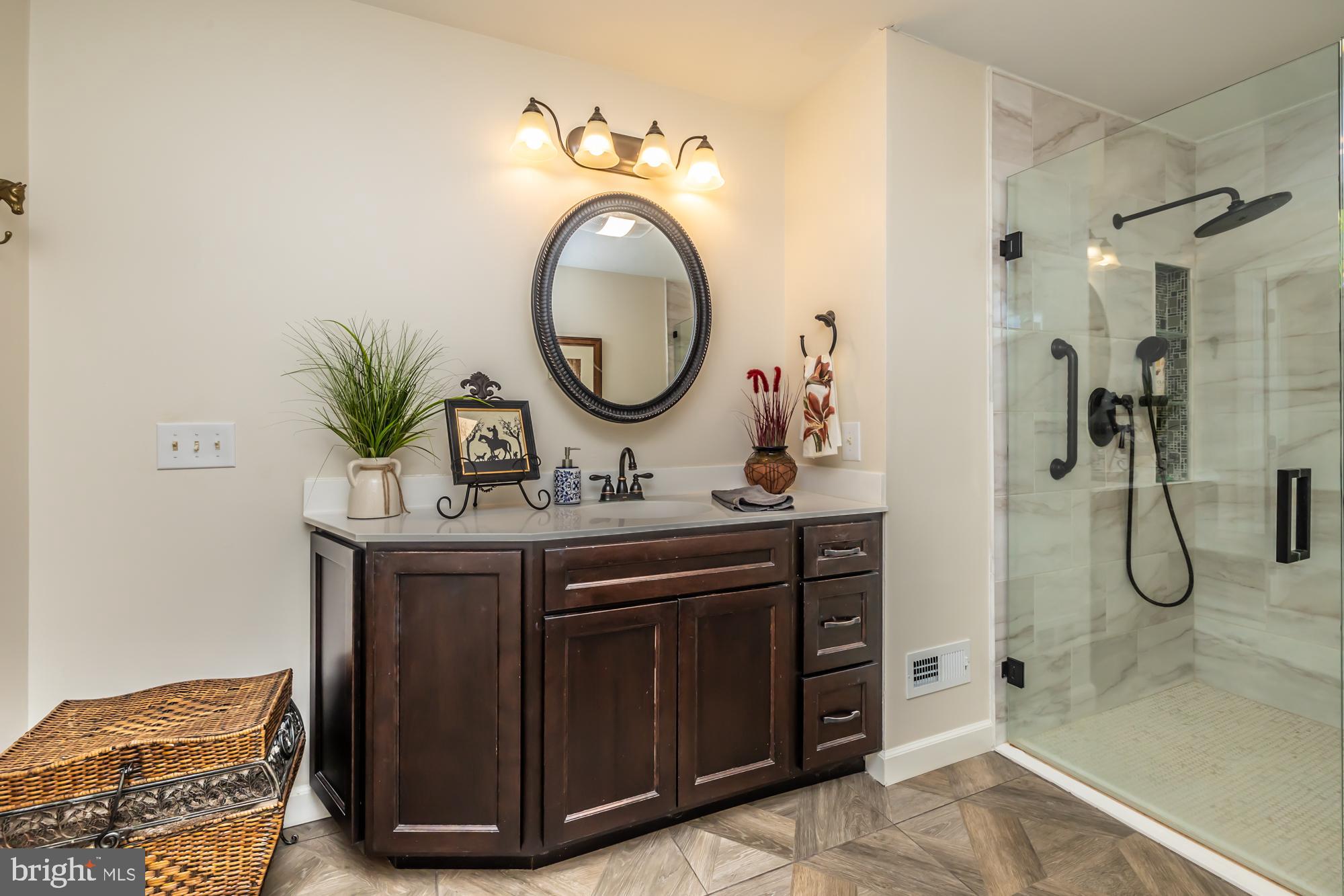 414 Manor Drive Kennett Square, PA 19348 - Photo 25 of 35 a bathroom with a granite countertop sink a mirror and shower