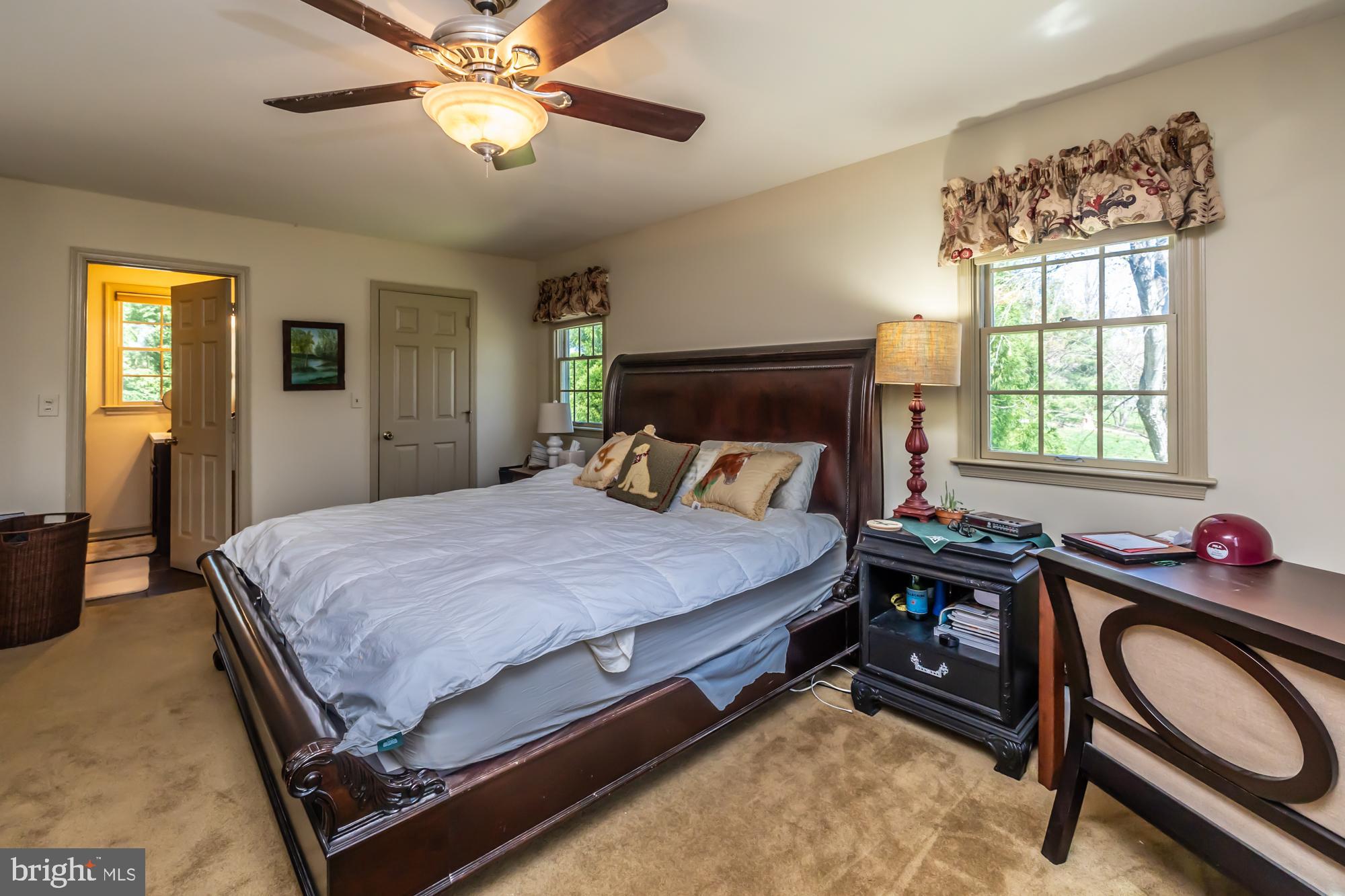 414 Manor Drive Kennett Square, PA 19348 - Photo 27 of 35 a bedroom with a bed and a chandelier