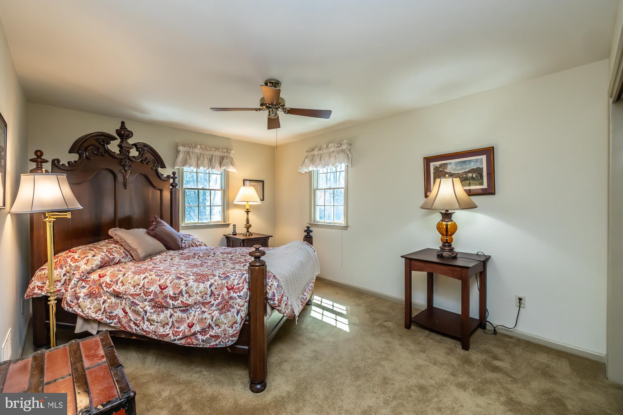 414 Manor Drive Kennett Square, PA 19348 - Photo 33 of 35 a bedroom with a bed and a chandelier