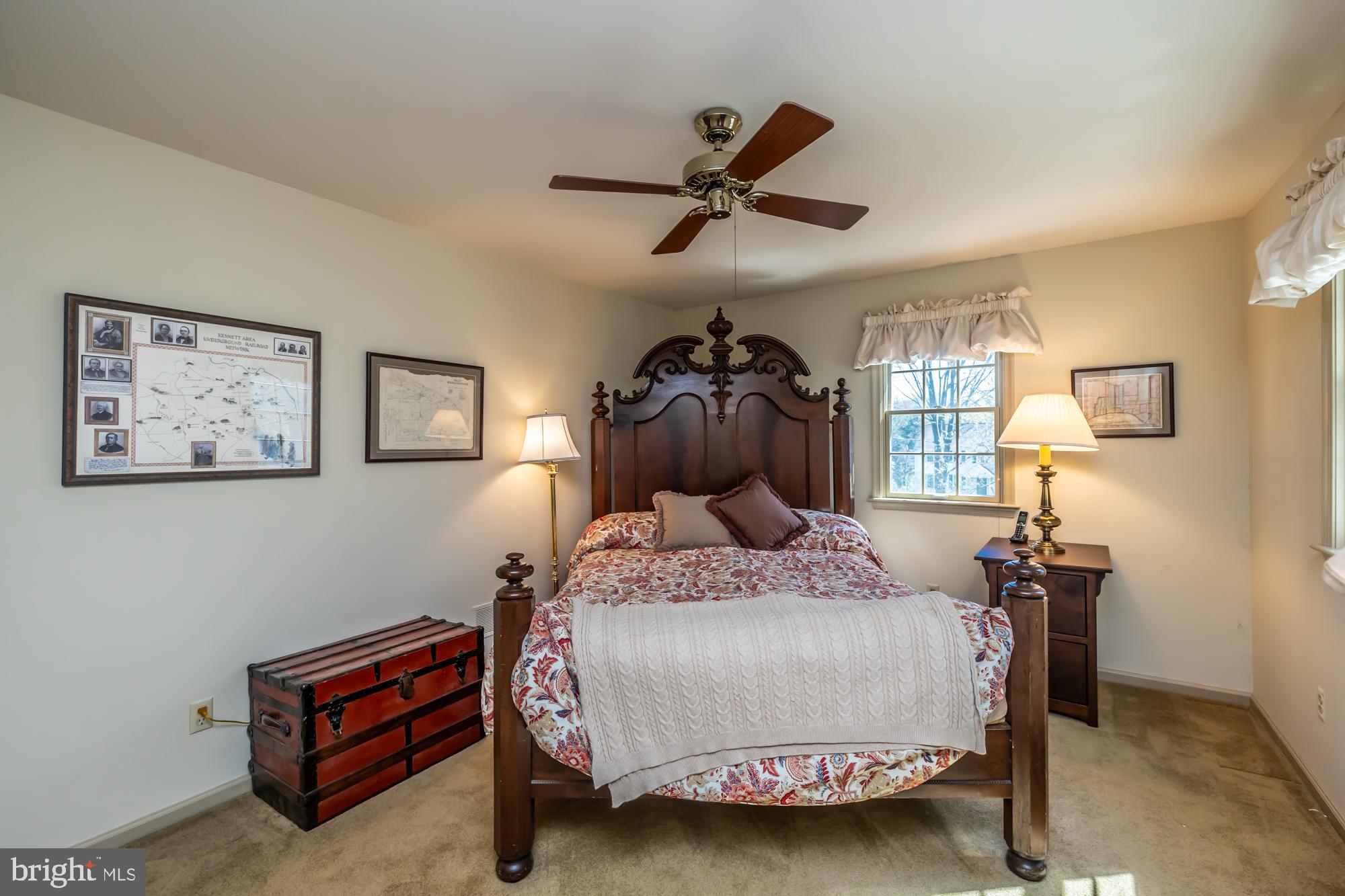 414 Manor Drive Kennett Square, PA 19348 - Photo 34 of 35 a bedroom with a bed and a chandelier