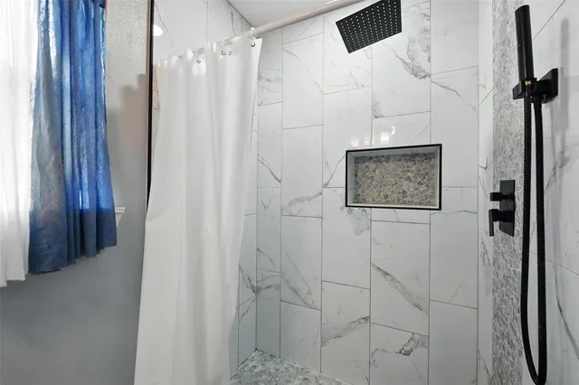 a bathroom with a shower and a sink