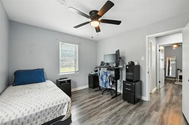 a bed room with wooden floor and a window