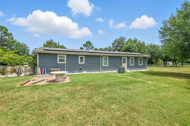 a view of a house with a yard and sitting area